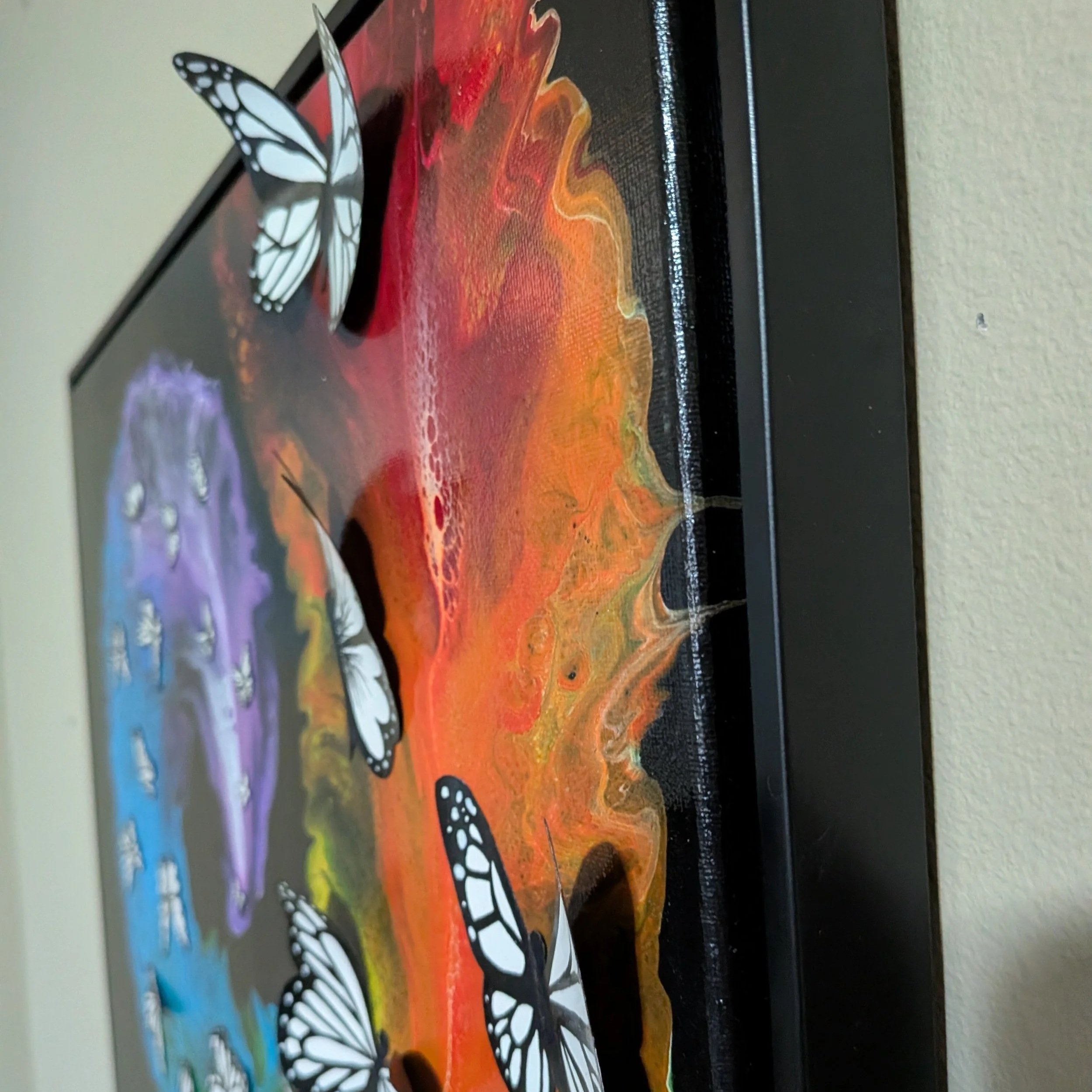 16x20 framed mixed media painting with a swirling rainbow composition and black-and-white butterflies, transitioning into 3D elements across the canvas