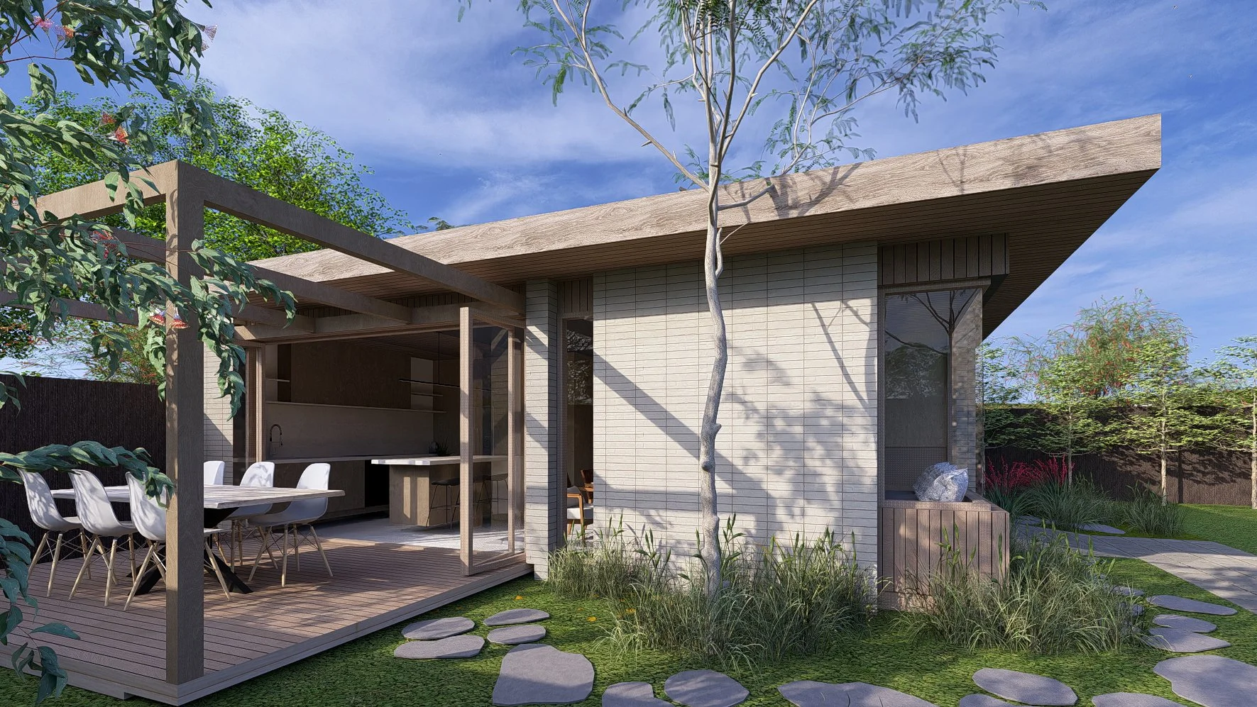 Modern house with a wooden deck and outdoor dining area, surrounded by greenery and trees, under a blue sky.