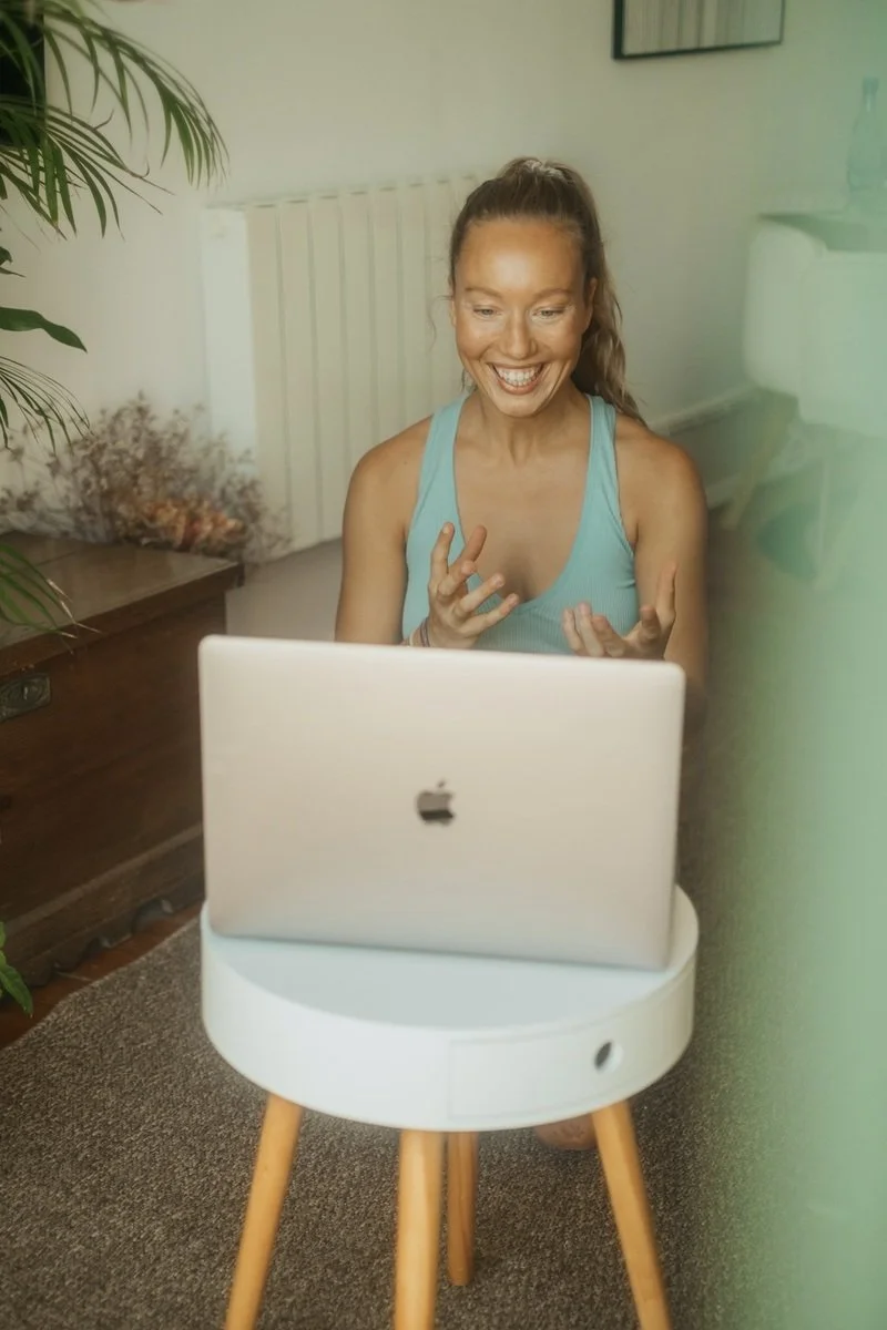 Lara Schäffer unterrichtet lächelnd vor dem Laptop, live über Zoom