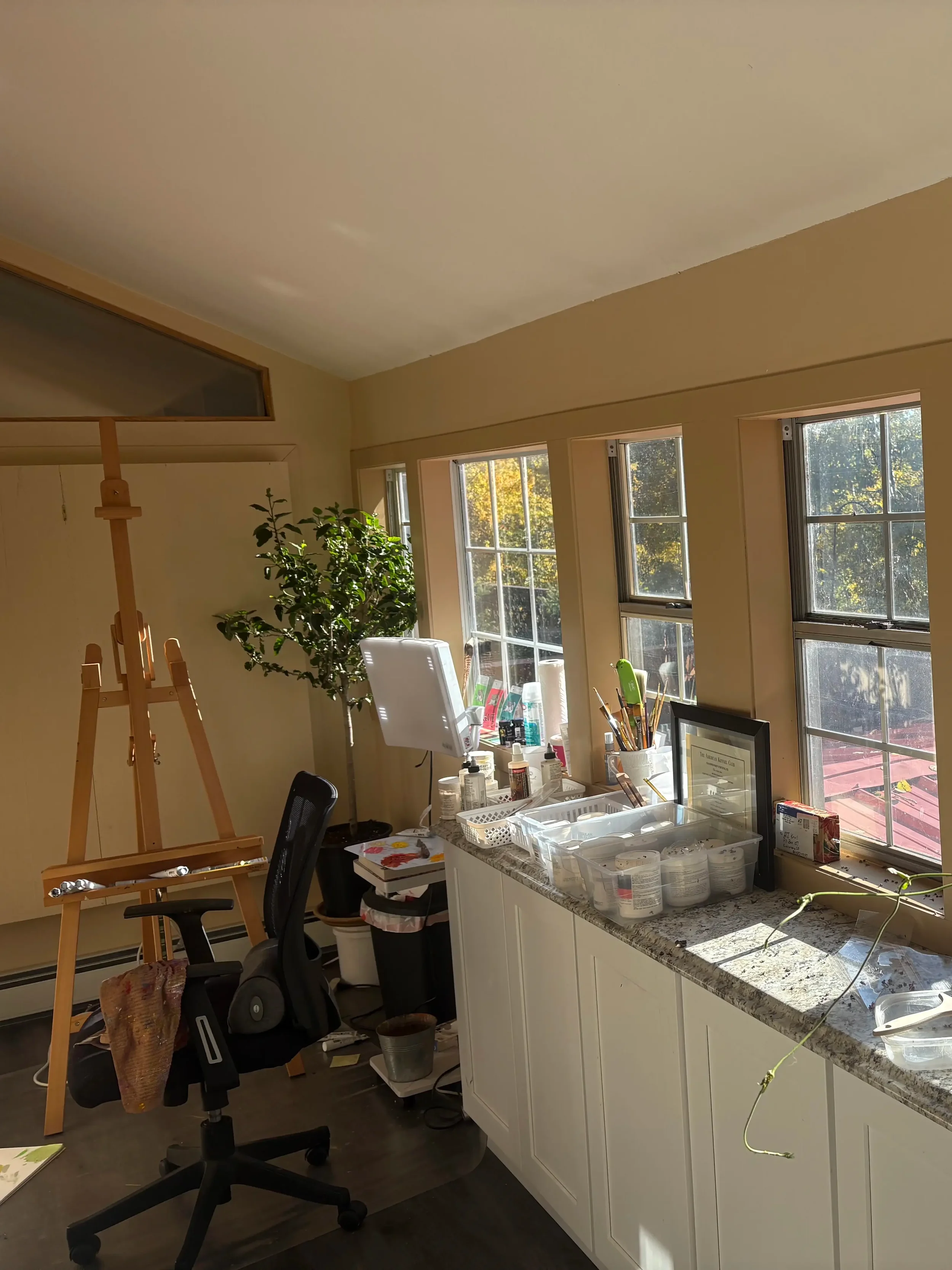 The art studio with an empty easel and art supplies