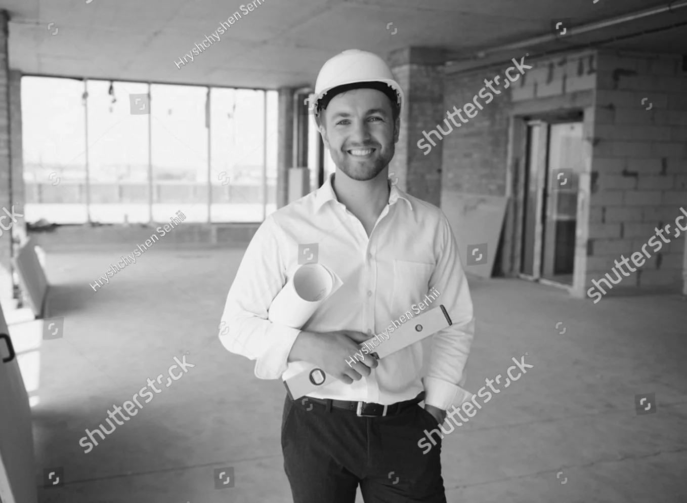 stock-photo-portrait-of-man-architect-at-building-site-confident-construction-manager-wearing-hardhat-2220935377.jpg