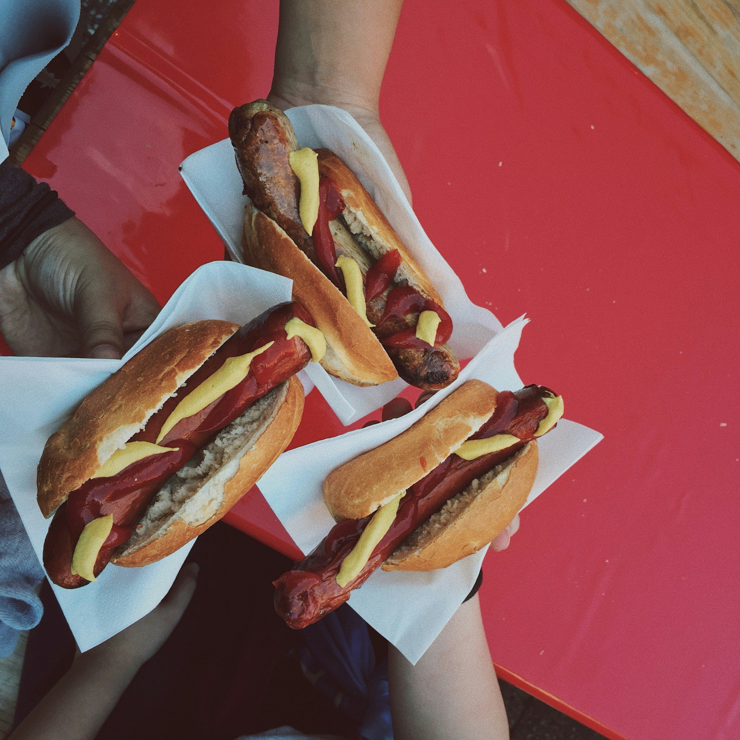 Hot dogs served with sauces at a staffed hot dog food stand
