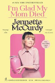 Book cover of 'I'm Glad My Mom Died' by Jennette McCurdy, featuring a young girl in a pink shirt holding a pink ceramic piggy bank against a pink background.