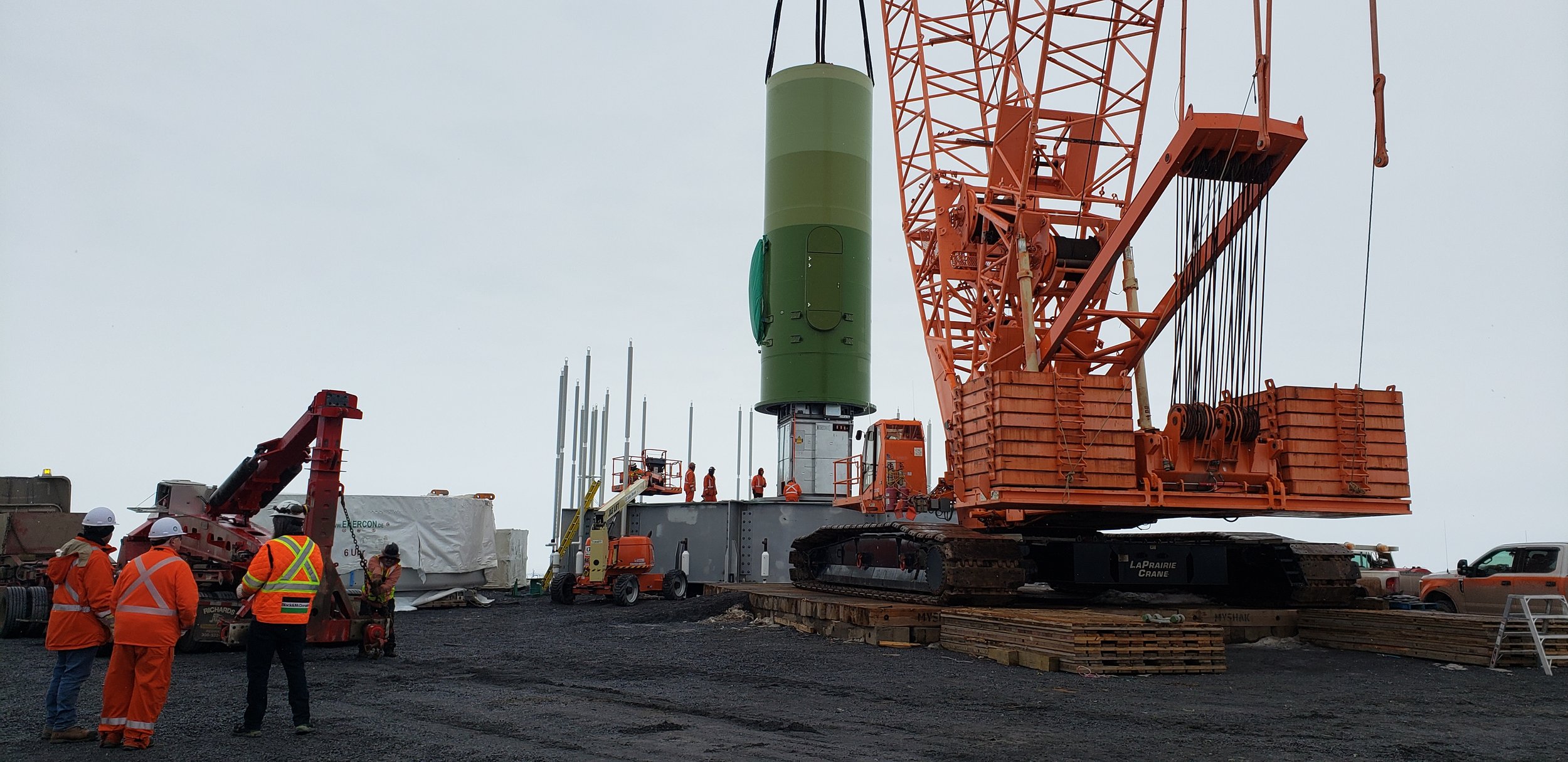 The first part of the turbine shaft being lowered into place on the steel infrastructure base.