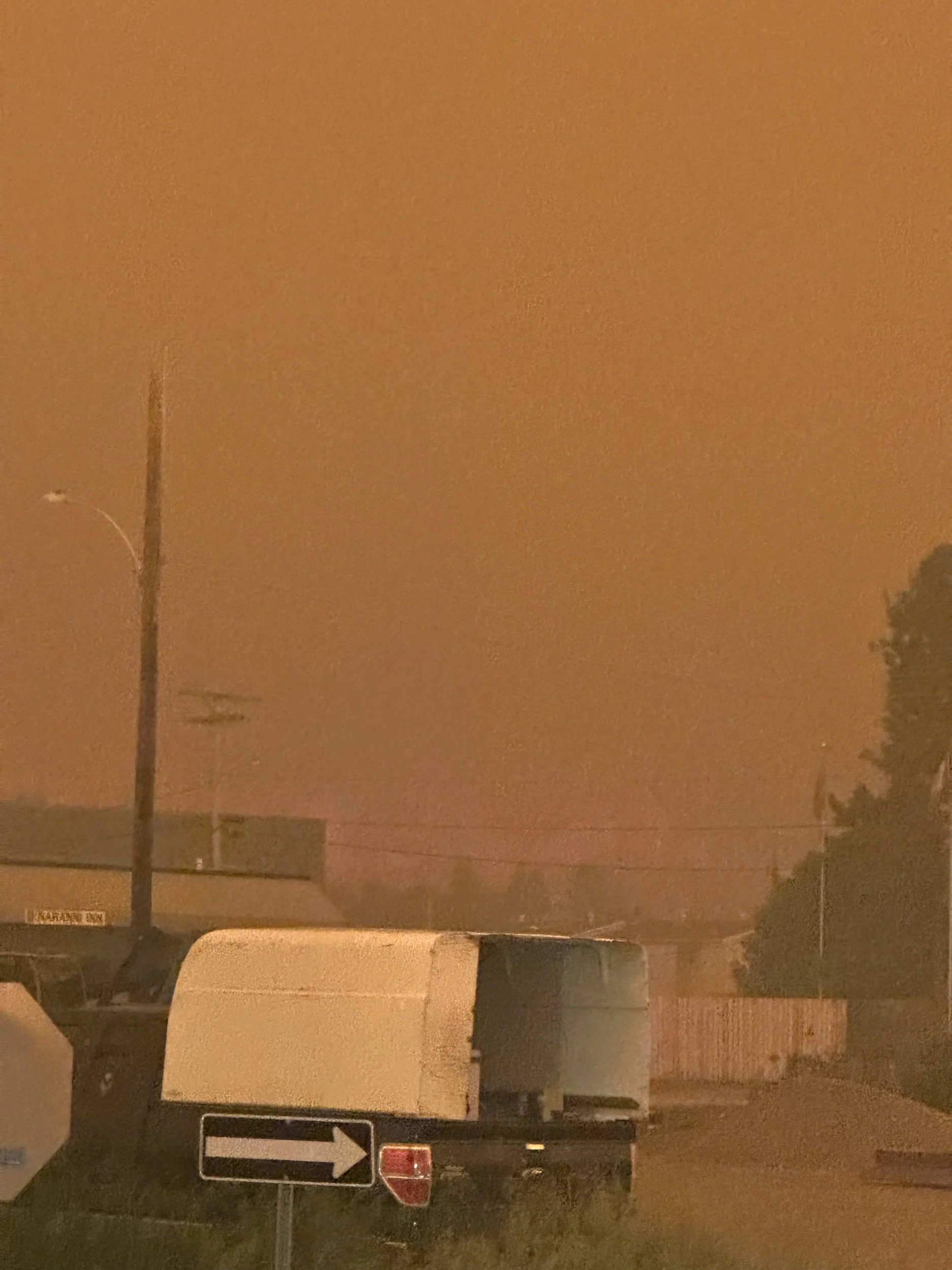 June 30: a firestorm approaches Fort Simpson from the west, visible through thick smoke
