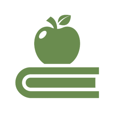 Green apple resting on top of a closed book.