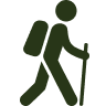 Silhouette of a person hiking with a backpack and walking stick