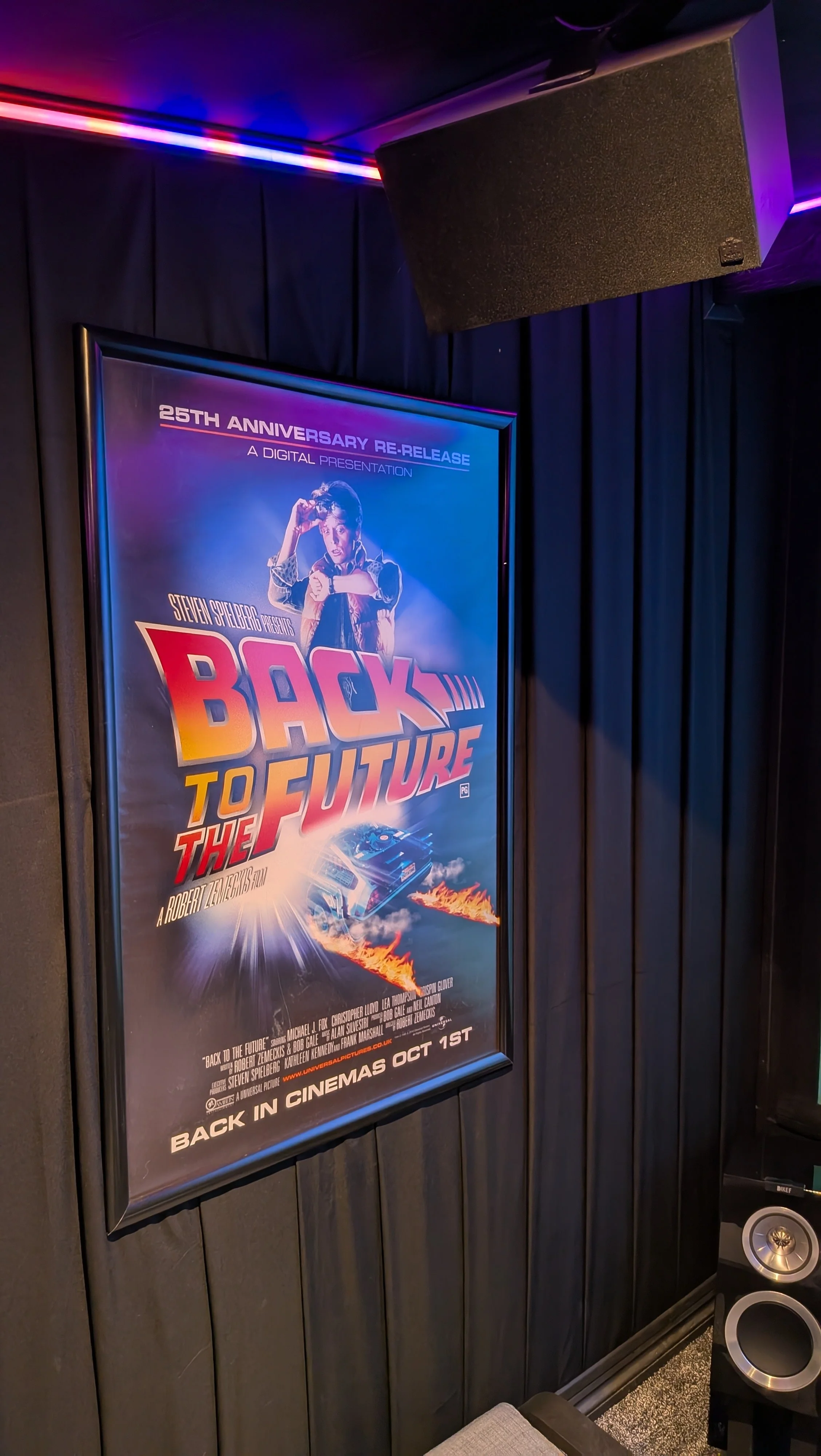Home Cinema: Back to the Future Poster with KEF Surround Sound Wall Speaker and Black Panel Walls