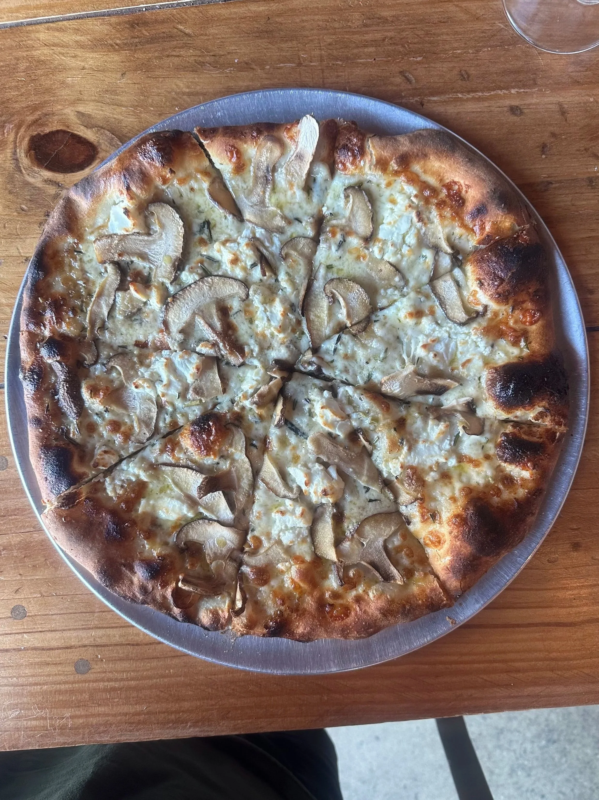 16" pizza pie with shitake and portobello mushrooms, rosemary, garlic, fontina, goat and mozzarella cheeses on sourdough crust and house made garlic cream sauce base.
