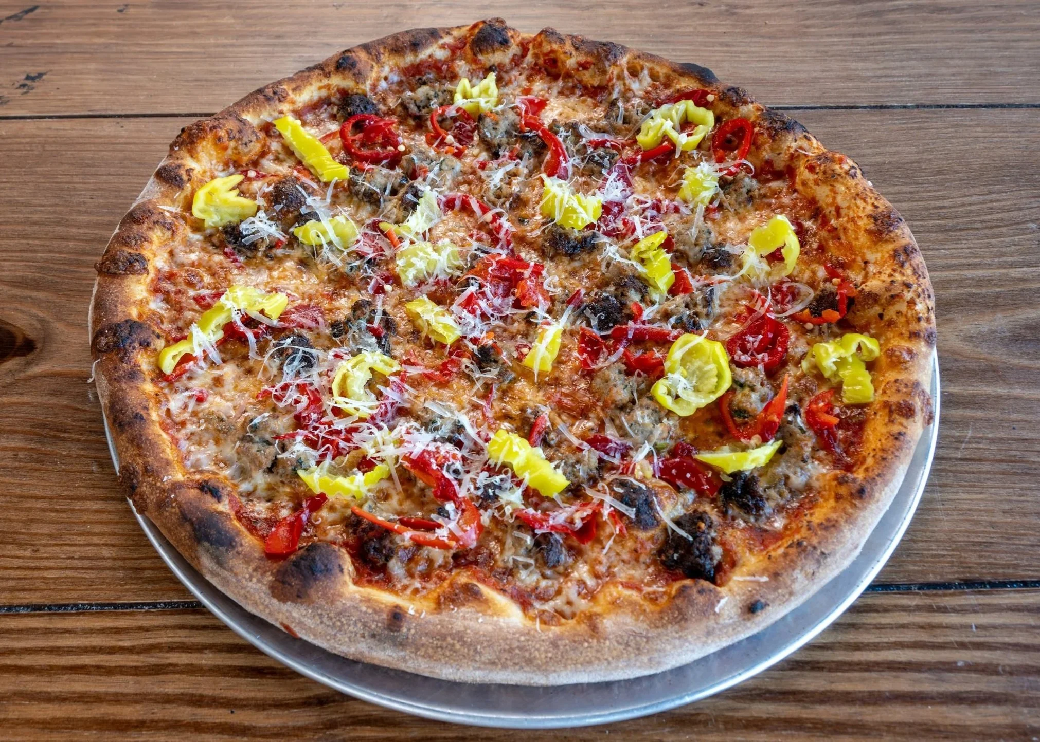 16" pizza pie with fennel sausage, roasted red peppers, tomato and basil red sauce base on sourdough crust with mozarella. finished with aged provolone.