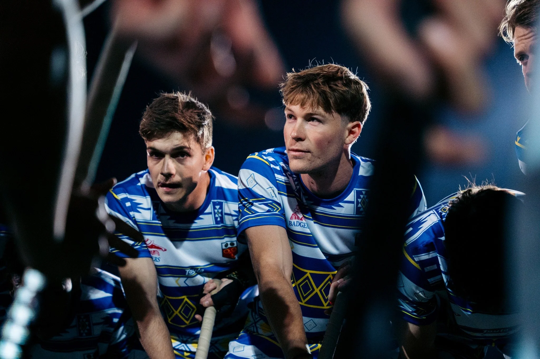 Hockey players in blue and white jerseys during a game.