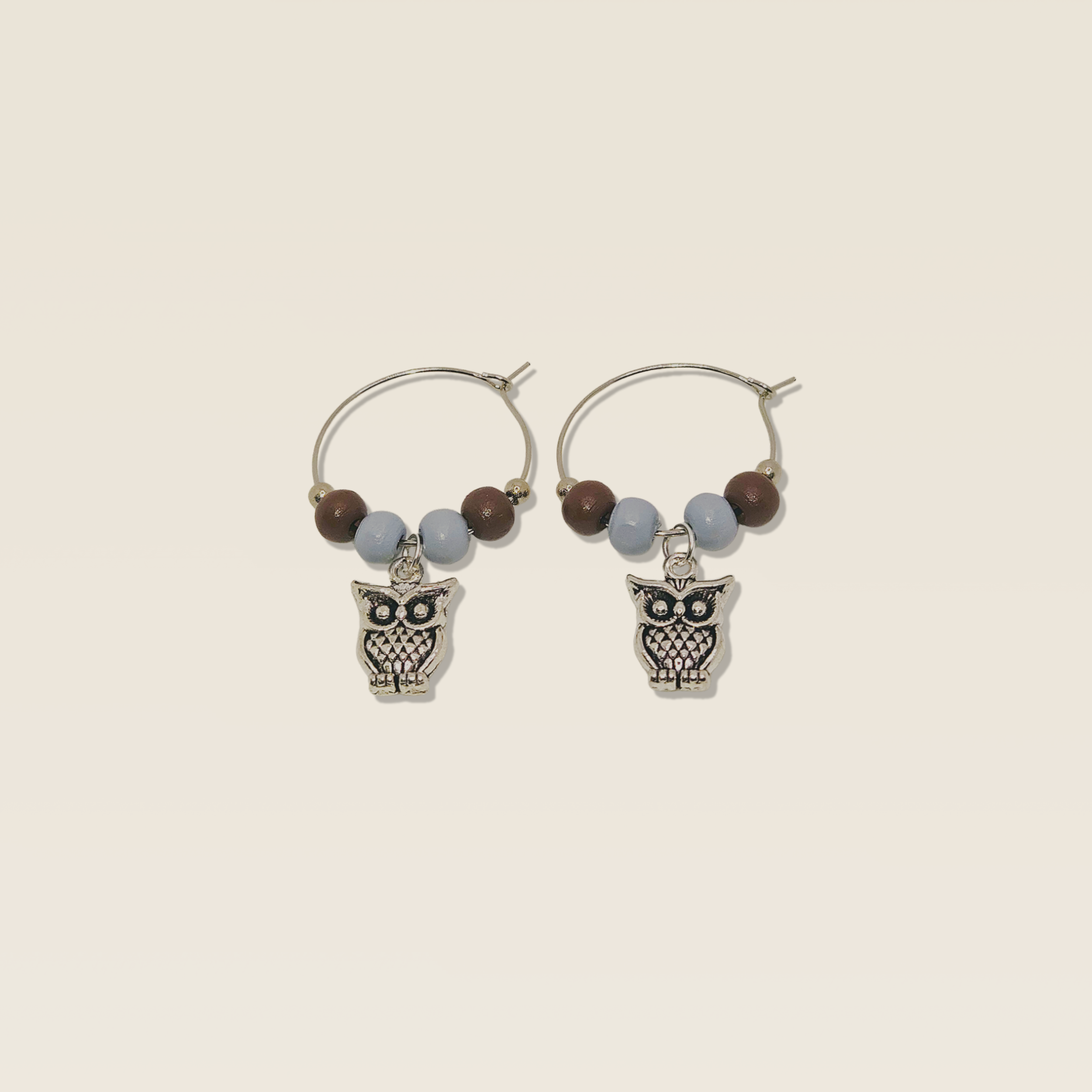 Feather & Sky wine charm duo with silver owl charms and soft neutral beads