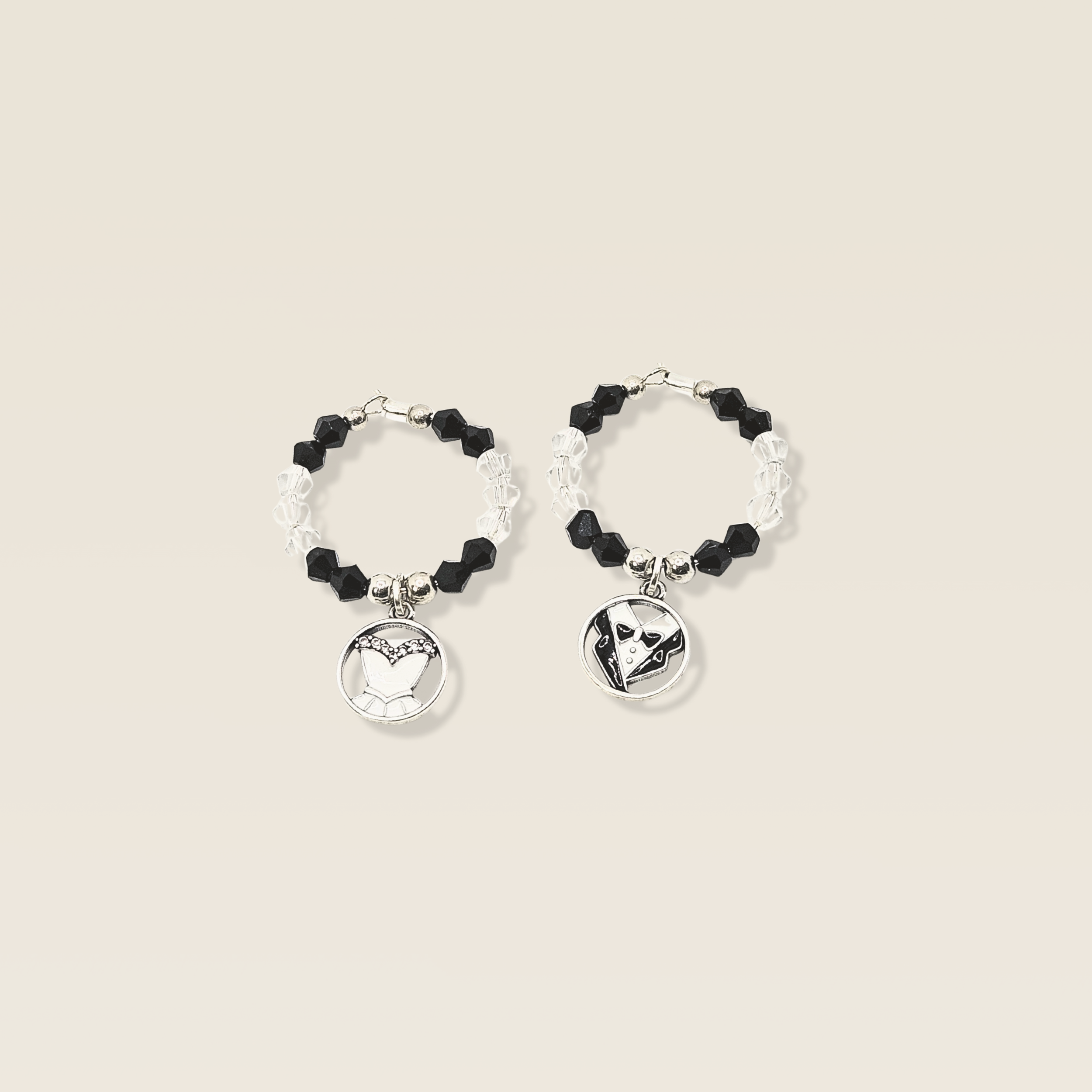 Mr and Mrs wine charms displayed on wine glasses with elegant wedding styling