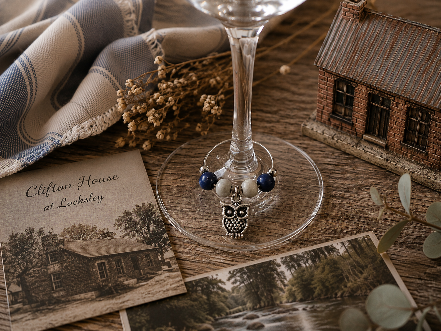 Riverbank Blue wine charm duo with silver owl charms and blue beads displayed on a wine glass