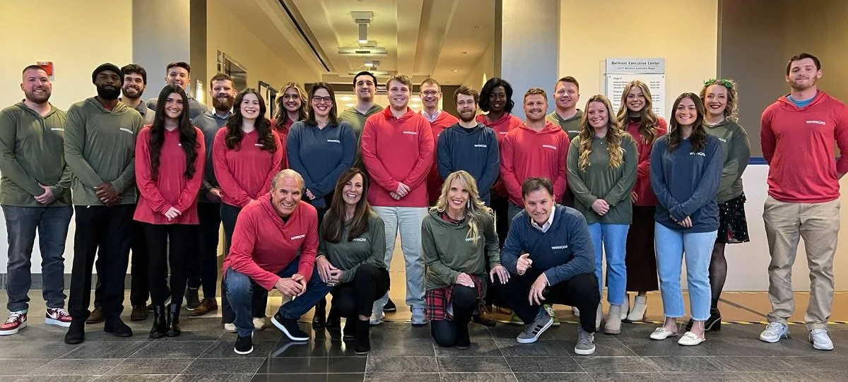 Group picture of the WSG team standing in lobby of WSG's HQ.