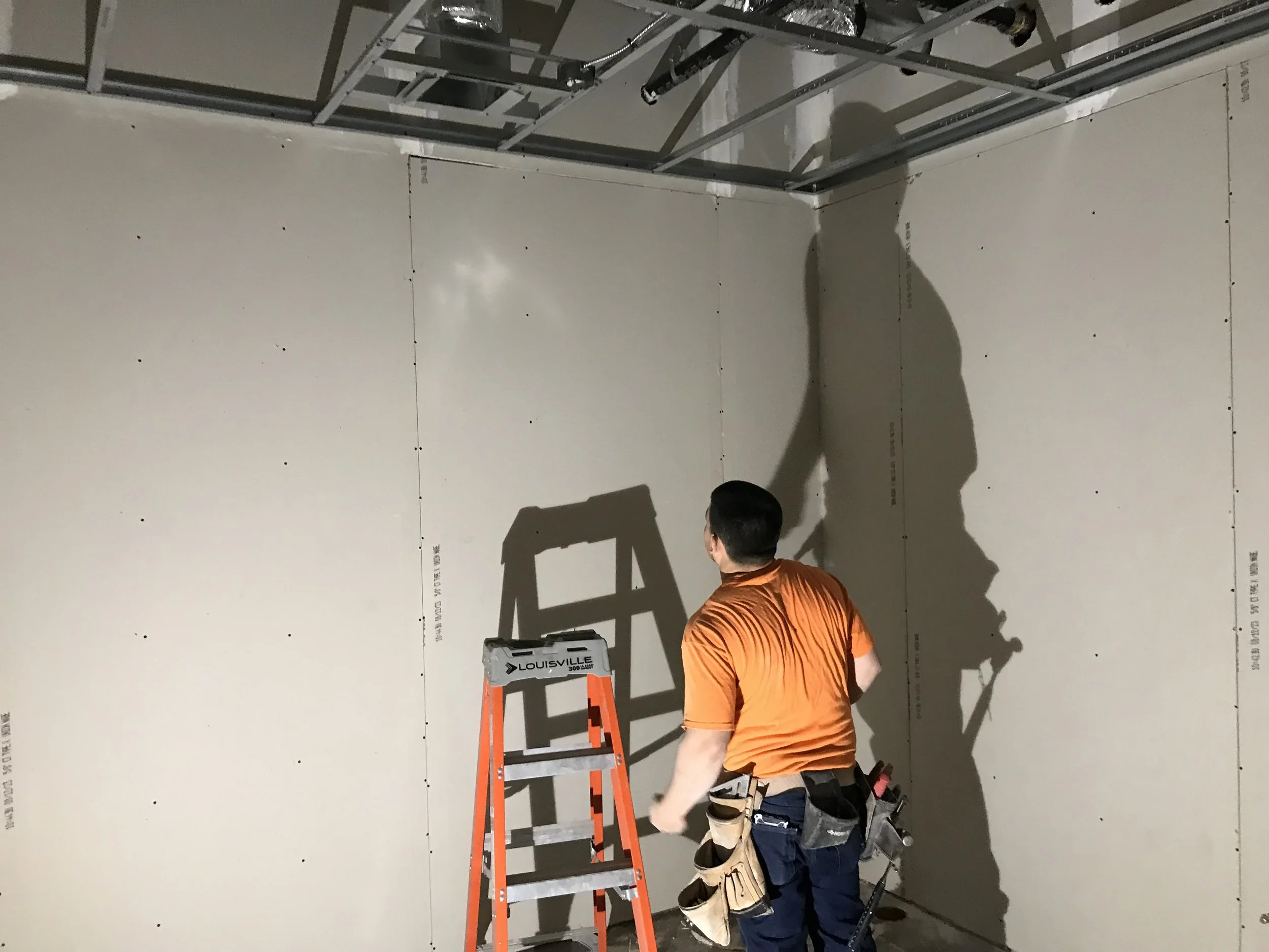 worker in front of drywall.jpg