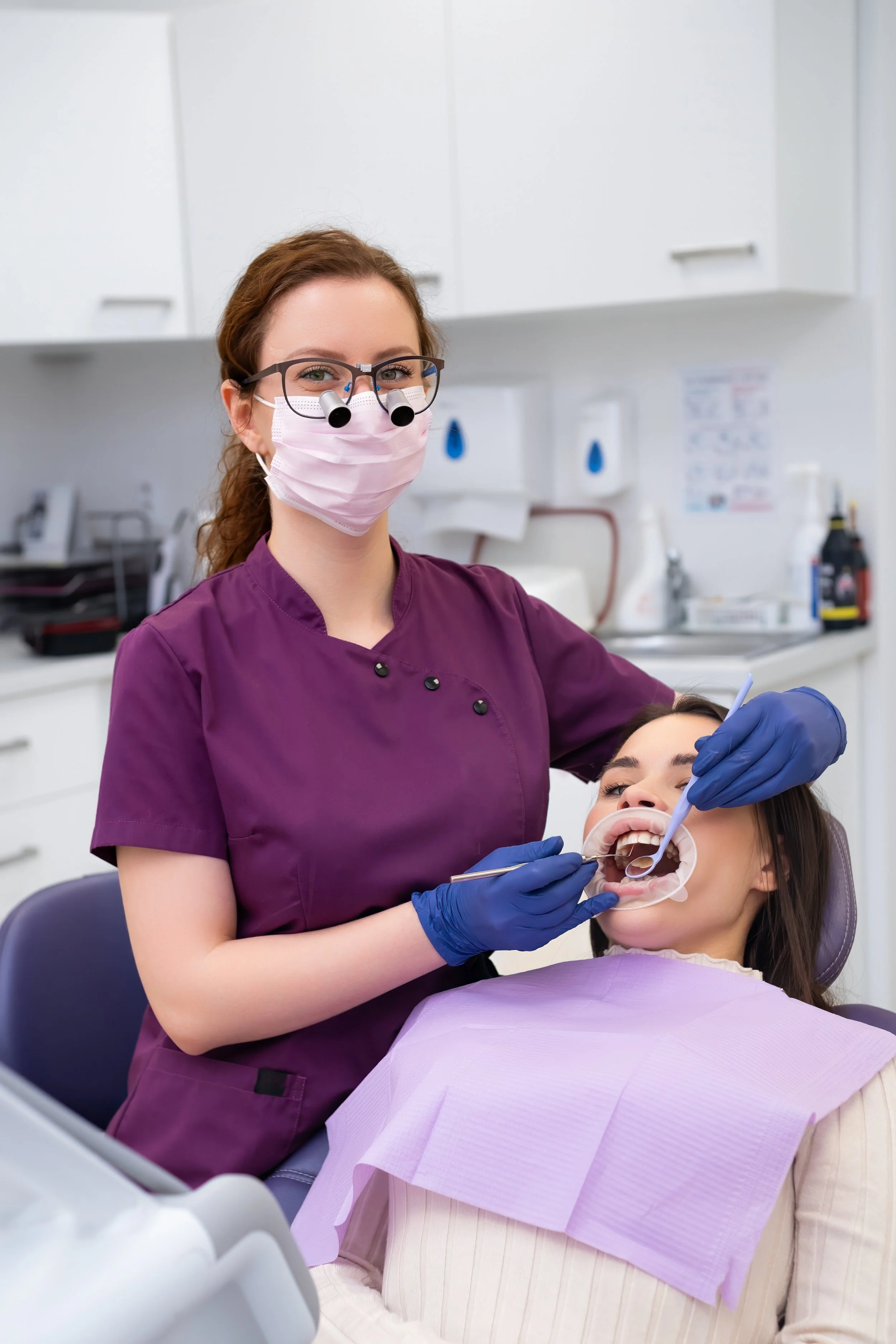 portrait-of-young-female-doctor-performs-teeth-tre-2025-03-08-07-35-41-utc.jpg