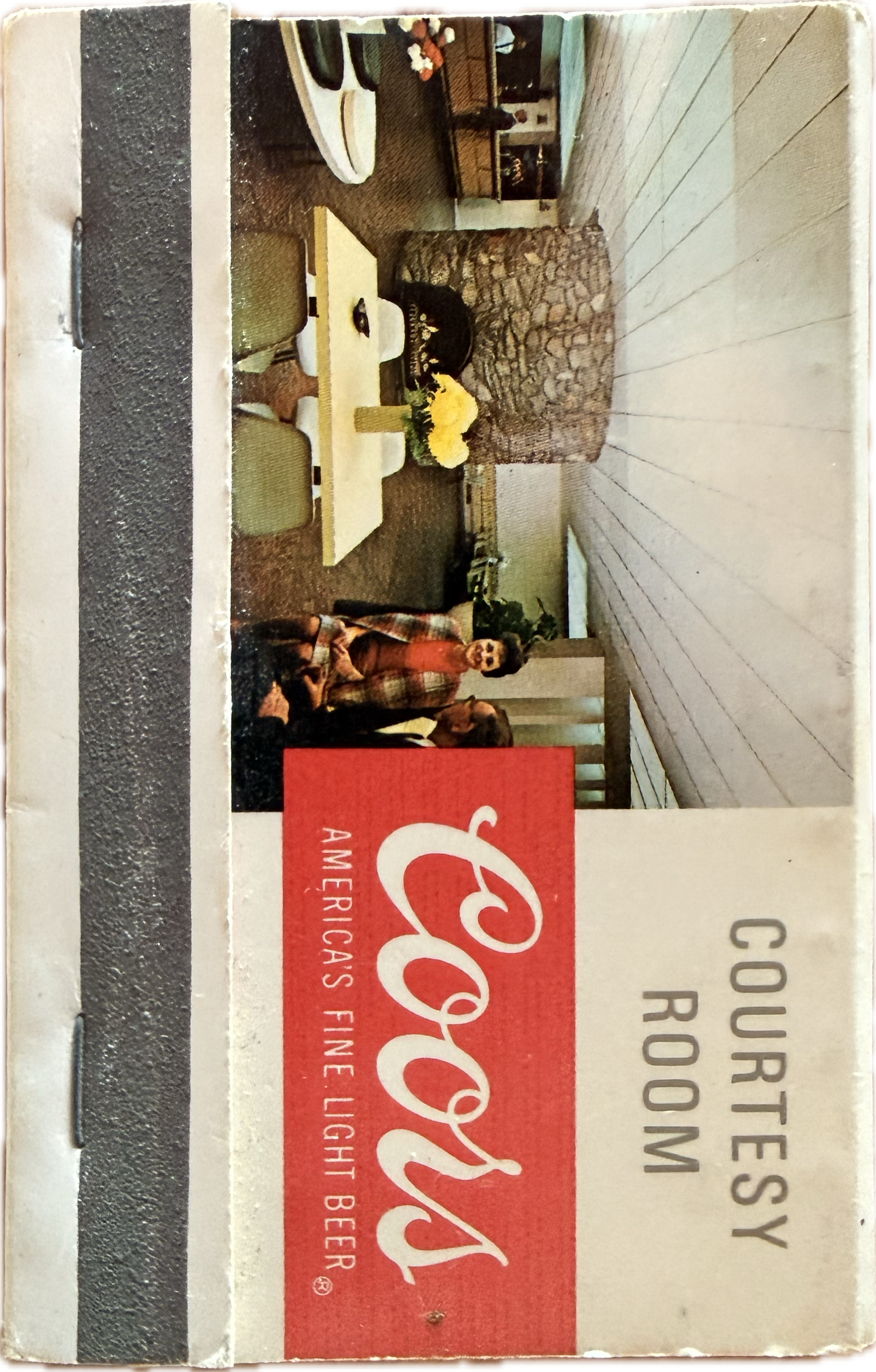 The backside of a vintage Coors “Courtesy Room” matchbook with the Coors Logo and a photo of the inside of the courtesy room.