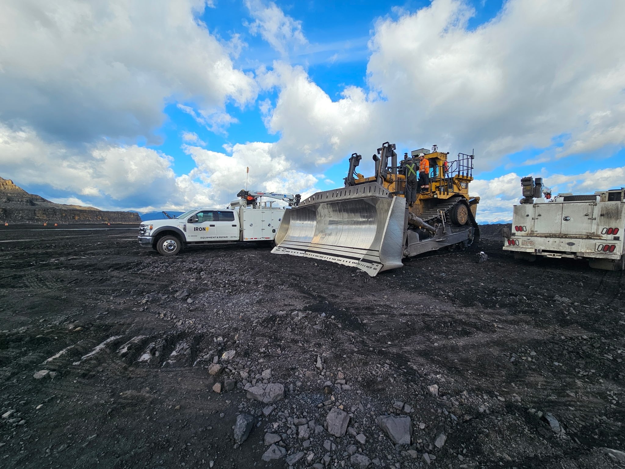 field mechanic performing on site heavy equipment repair with IRON 5 mobile service truck