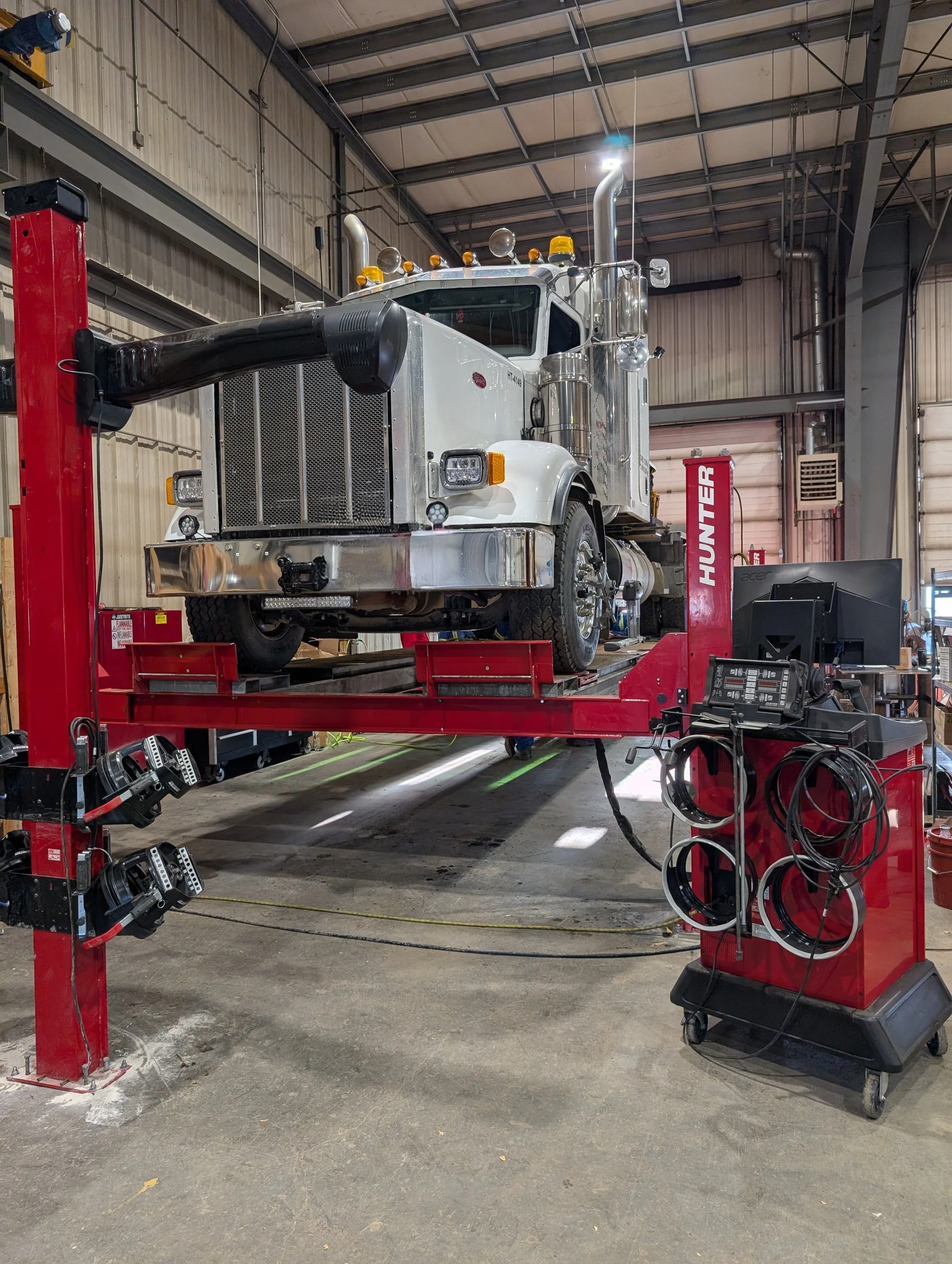 heavy duty commercial truck on alignment rack at IRON 5 shop in Nisku Alberta