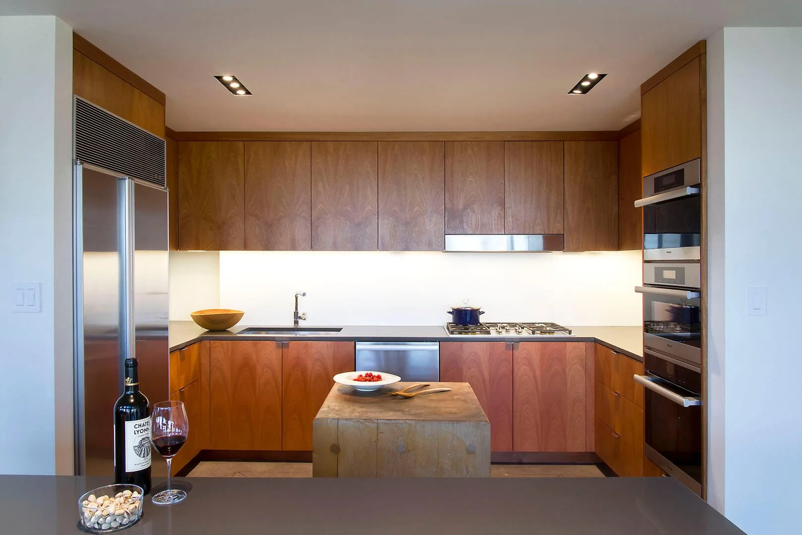 Modern kitchen with walnut cabinetry and a butcher-block island, Governors Plaza South, Salt Lake City, Utah.