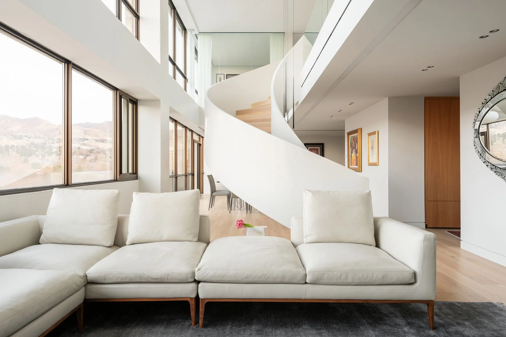 Modern open-concept living room with floor-to-ceiling windows overlooking Salt Lake City, Governors Plaza North, Salt Lake City, Utah.