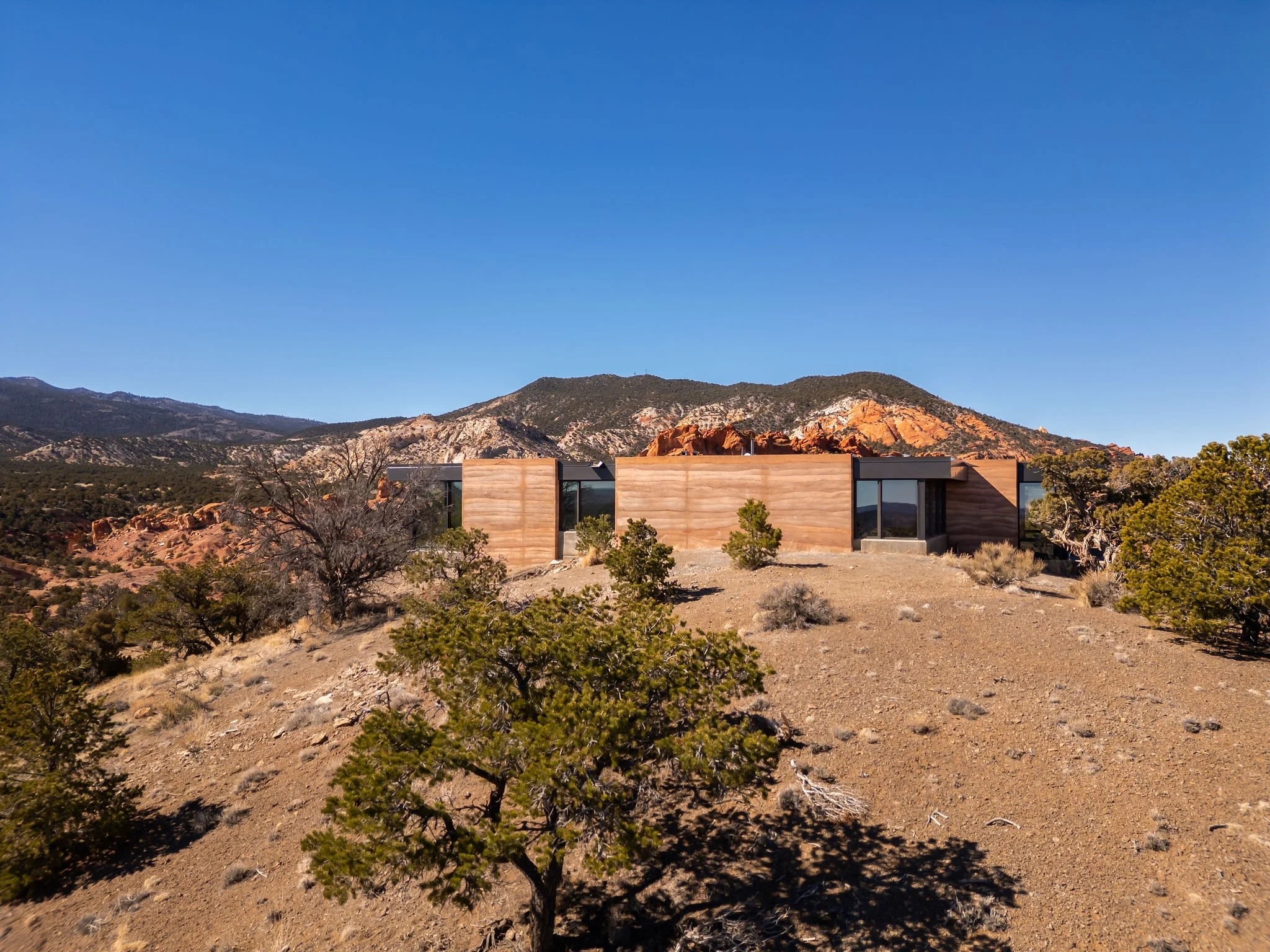 a home surround by red rock desert