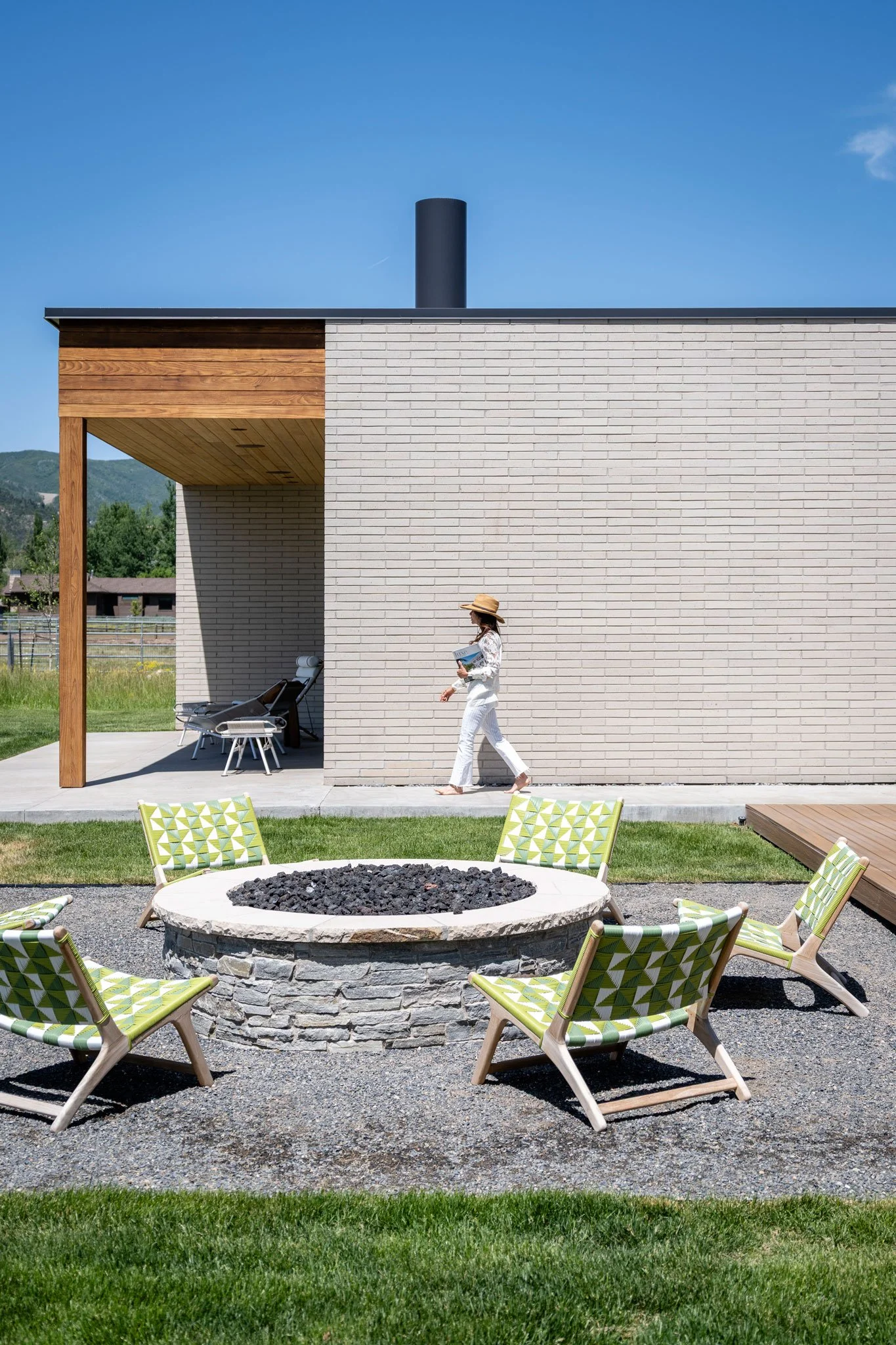 Outdoor fire pit and seating beside the modern brick home, Spring Creek, Park City, Utah.