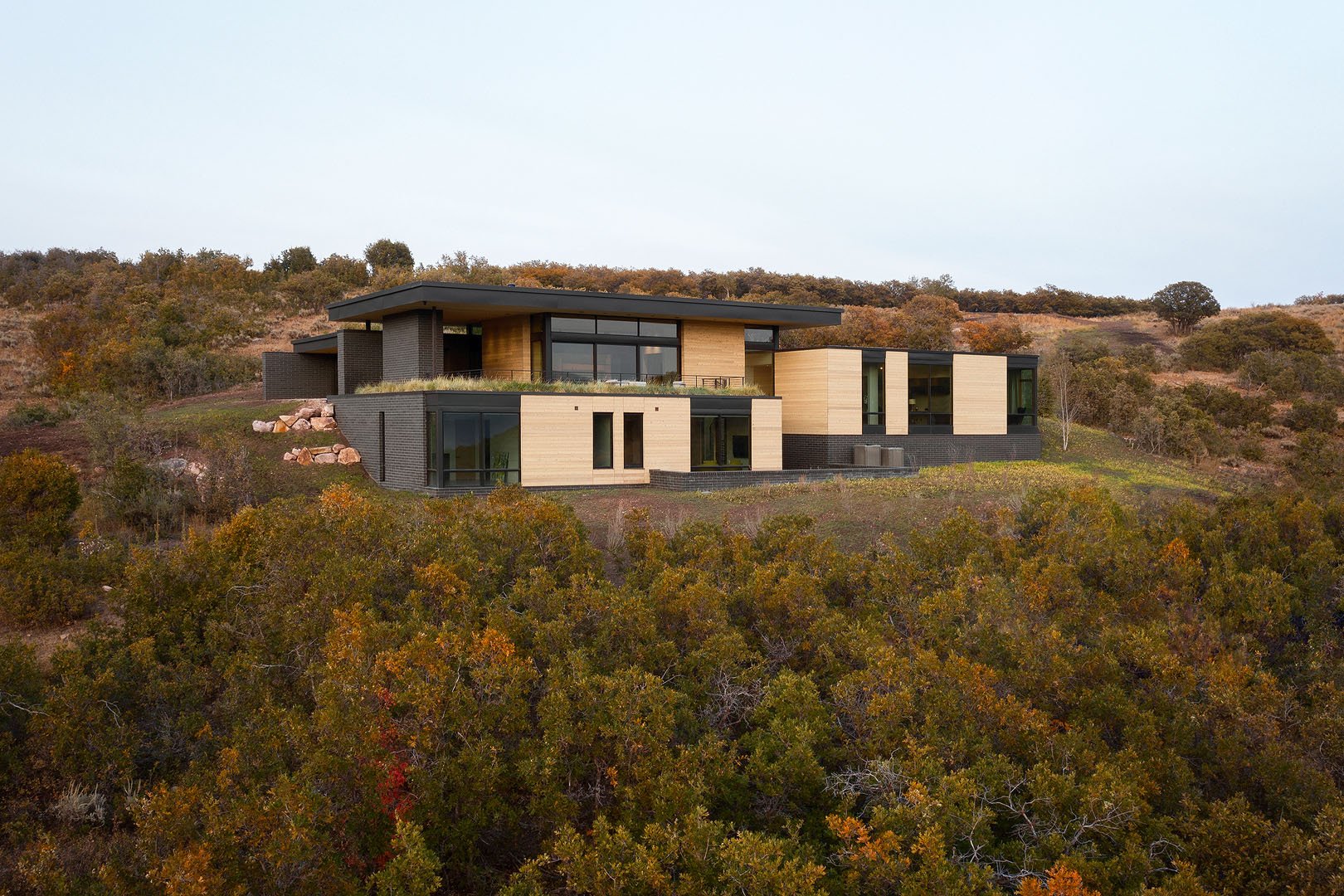 Modern stepped mountain home in brick and hemlock with floor-to-ceiling glass, Silver Summit, Park City, Utah