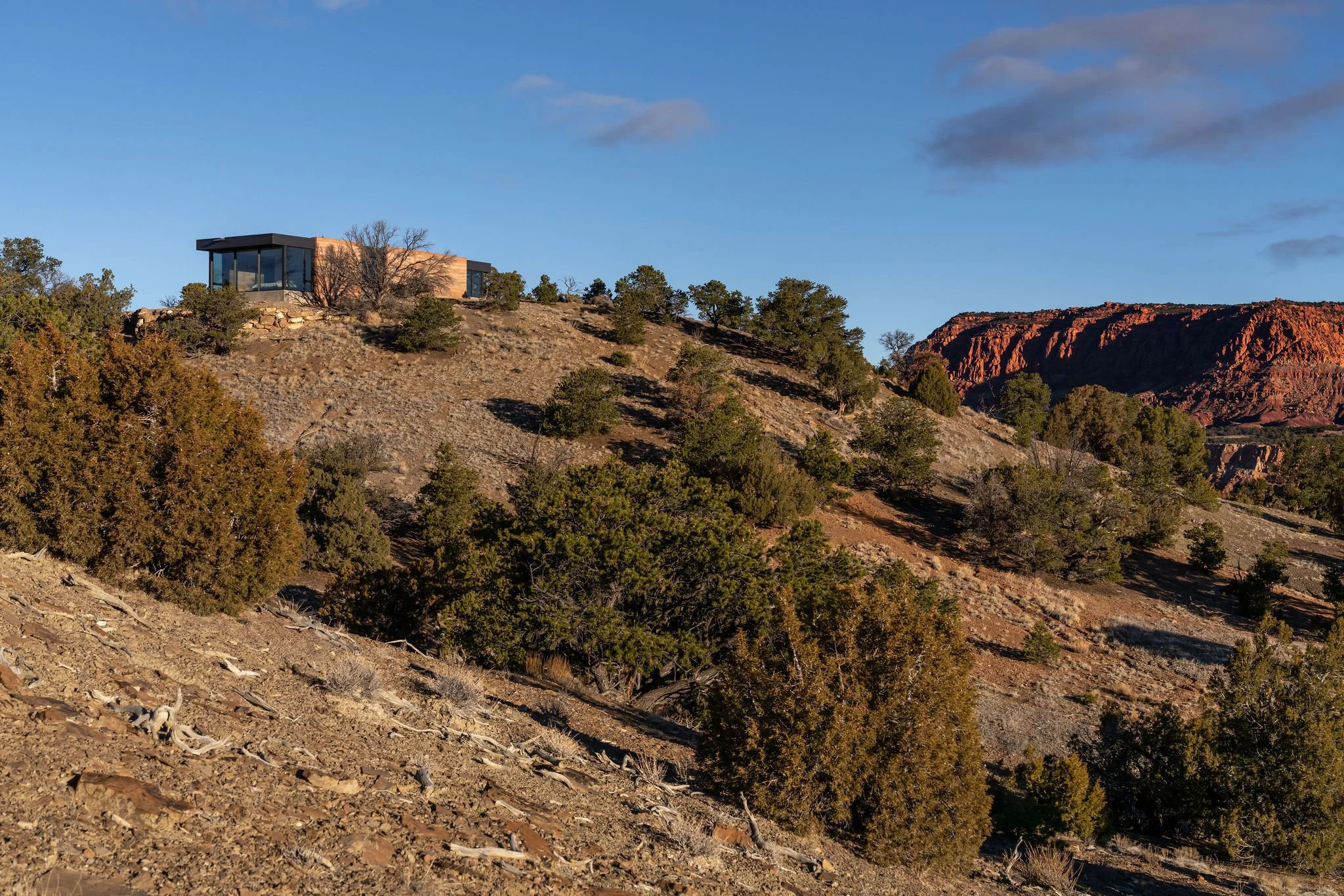 remote home against a desert bluff