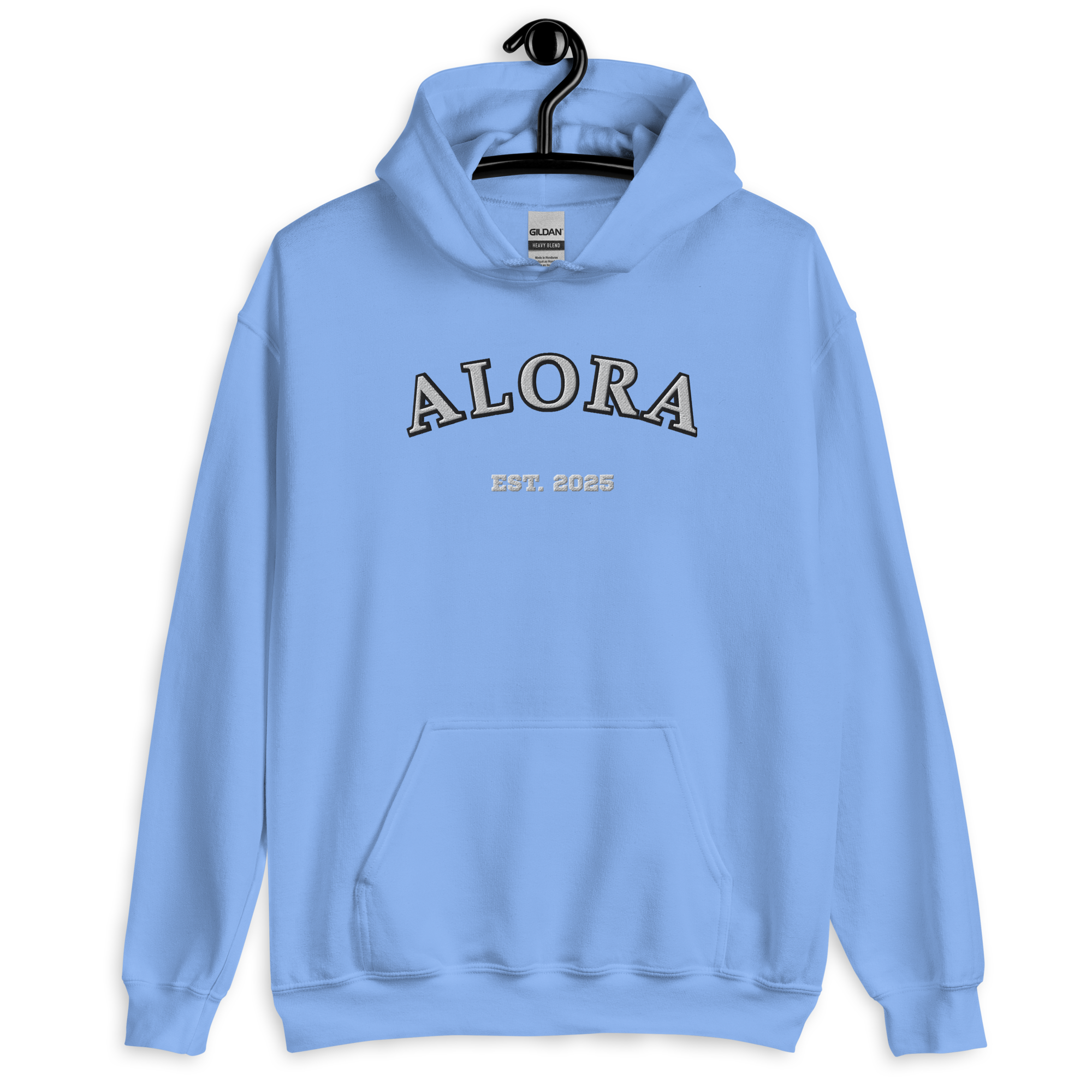 Light blue hoodie with black and white embroidered text 'ALORA' and smaller text 'EST. 2025' on the front, hanging on a black hanger against a black background.