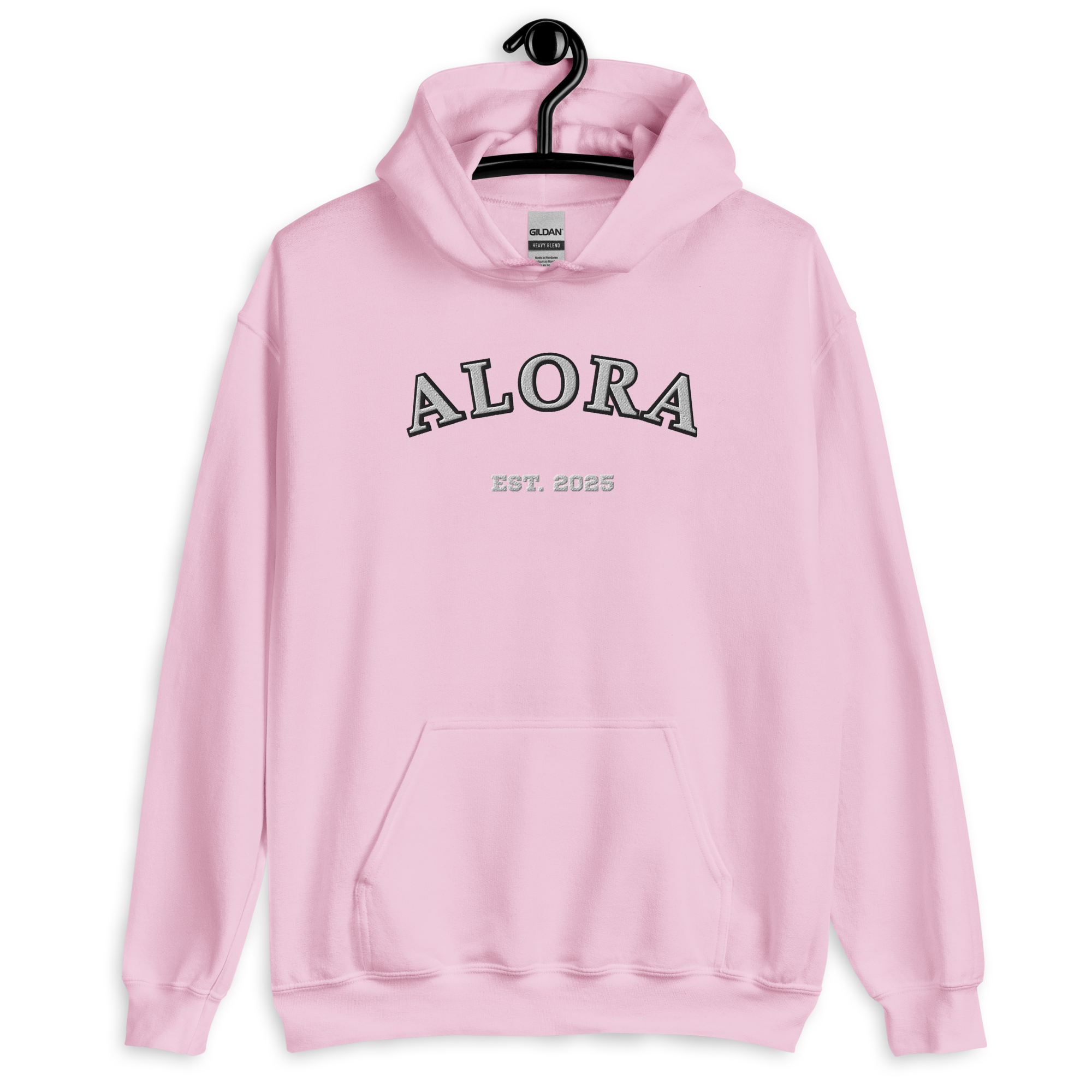 Pink hoodie with the word 'ALORA', 'EST. 2025' printed on the front, hanging on a black hanger against a black background.