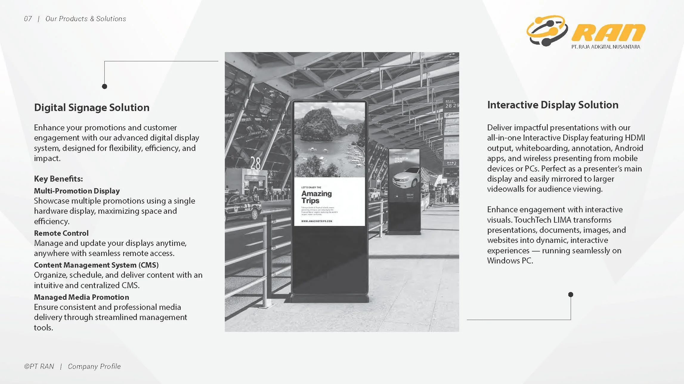 Page from a brochure or presentation slide describing digital signage and interactive display solutions by PT Raja Adigital Nusantara. Includes a photo of digital signage displays inside a building, possibly an airport or train station, with text promoting advanced digital display systems and interactive presentation features.
