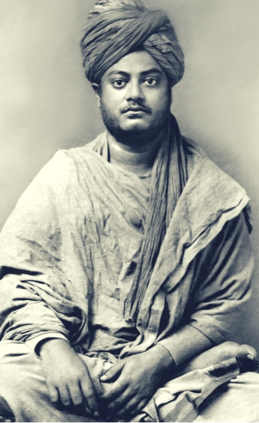 Black and white portrait of a man wearing traditional Indian attire with a turban, sitting with hands resting on his lap.