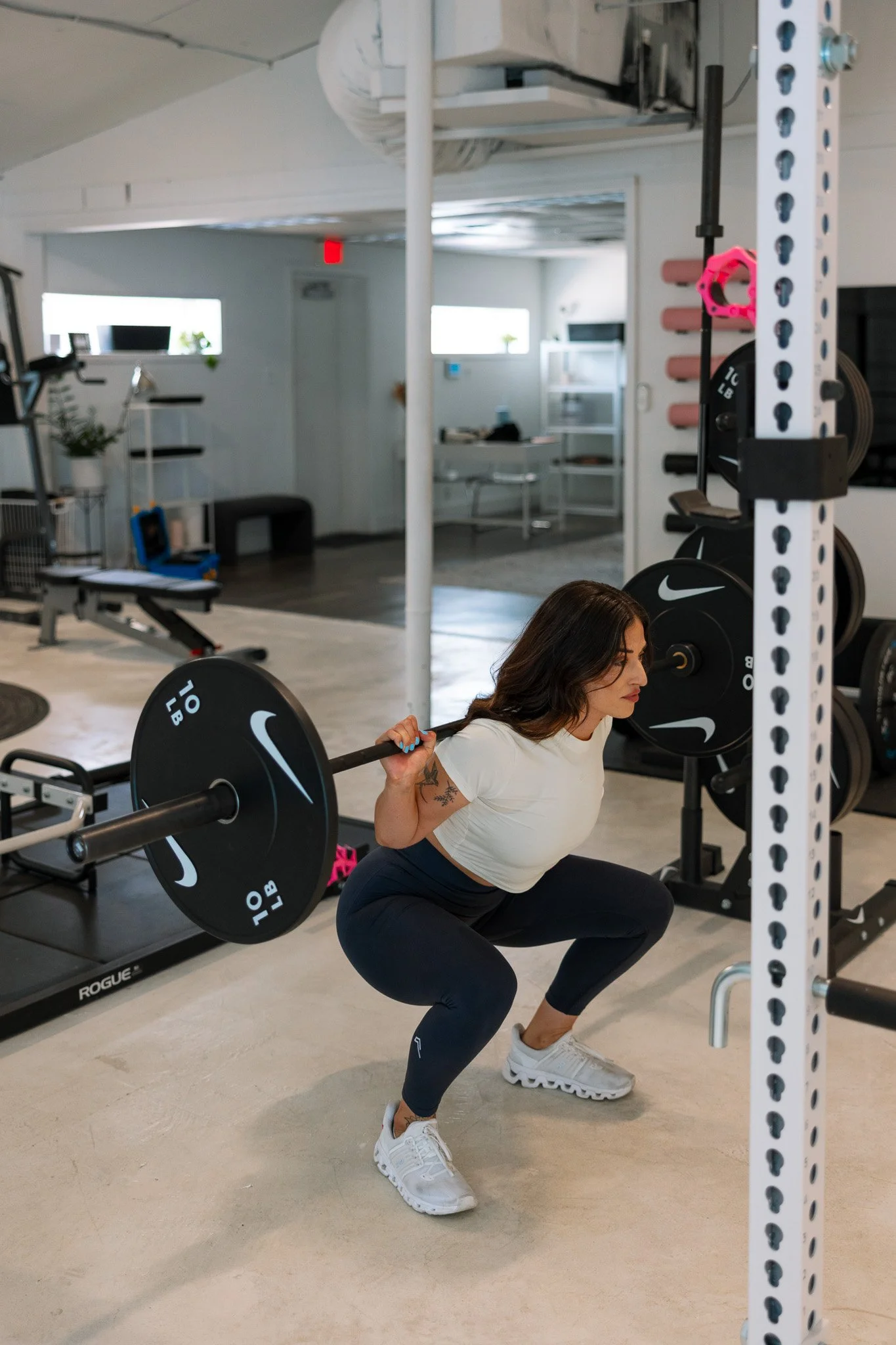 Stacia Evans, women's strength coach in Austin, doing a barbell back squat