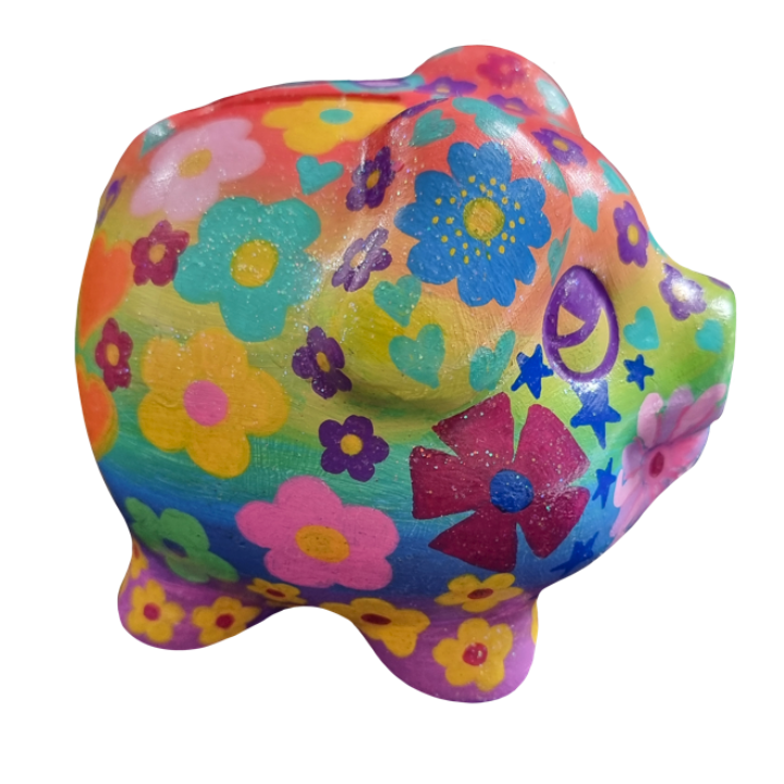 Colorful painted rock resembling a cartoonish animal with floral patterns and doodles.