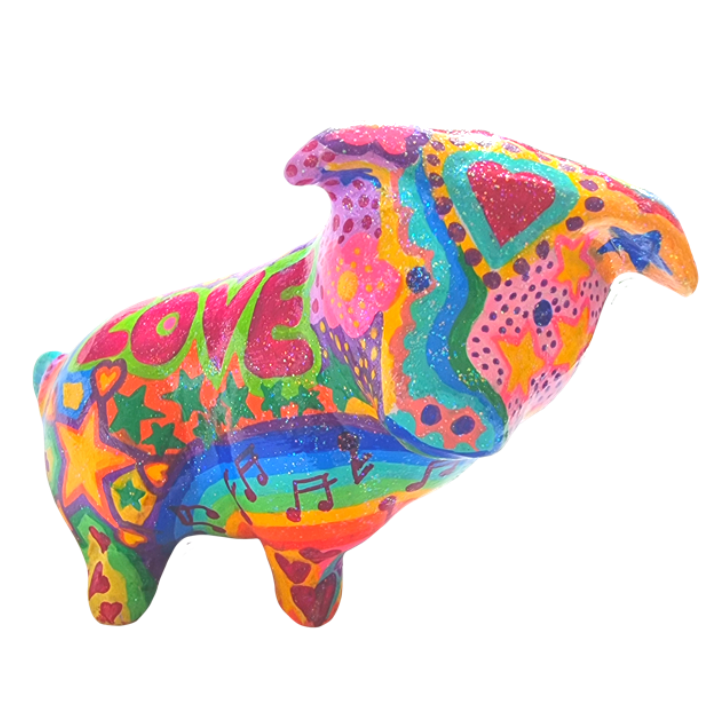 Colourful, decorated pig sculpture with words like 'LOVE', musical notes, hearts, stars, and vibrant patterns.