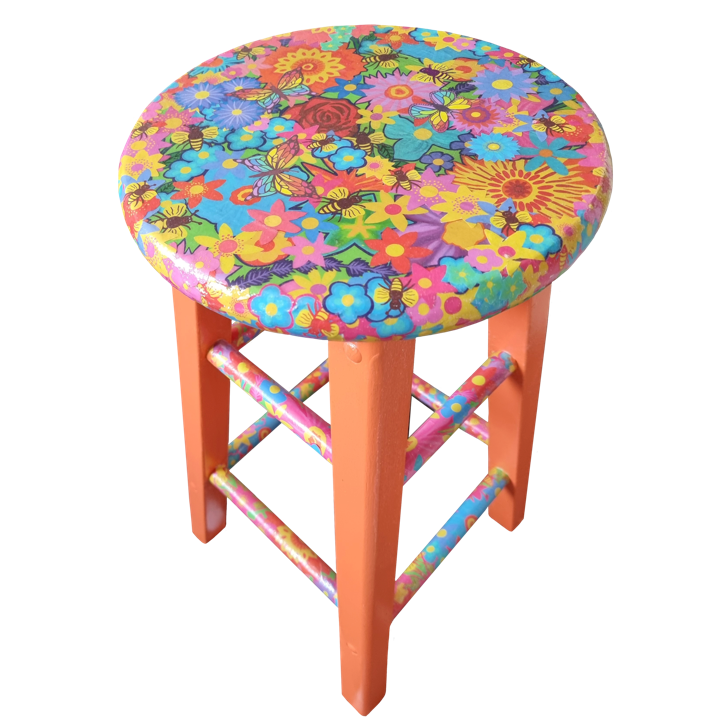 Colourful stool with a round top featuring a floral and bee pattern, with pink legs and crossbars decorated with similar vibrant designs.