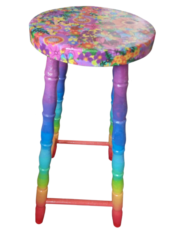 Colourful stool with a floral pattern on the round seat and rainbow-colored legs.