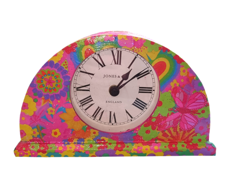 Colourful floral and butterfly design clock with Roman numerals showing the time as 2:09.