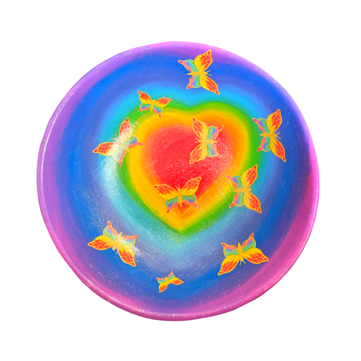 Colourful rainbow heart bowl with rainbow butterflies on a rainbow-gradient background