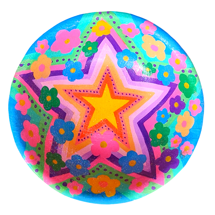 Colourful bowl with a large yellow star at its center, surrounded by layered pink and purple stars, with pink, blue, green, and orange flowers around the stars on a vibrant blue background.