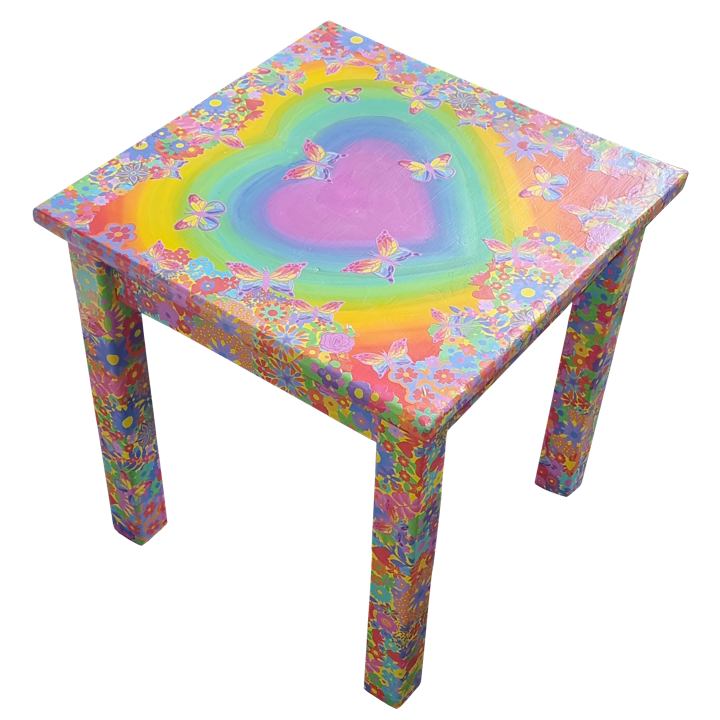 Colourful square table decorated with rainbow, pink heart, butterflies, and floral patterns in vibrant pastel shades.