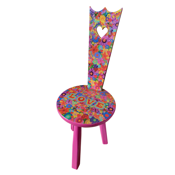 Colourful chair with a floral pattern, a heart-shaped cutout on the backrest, and the word 'LOVE' spelled out on the seat.