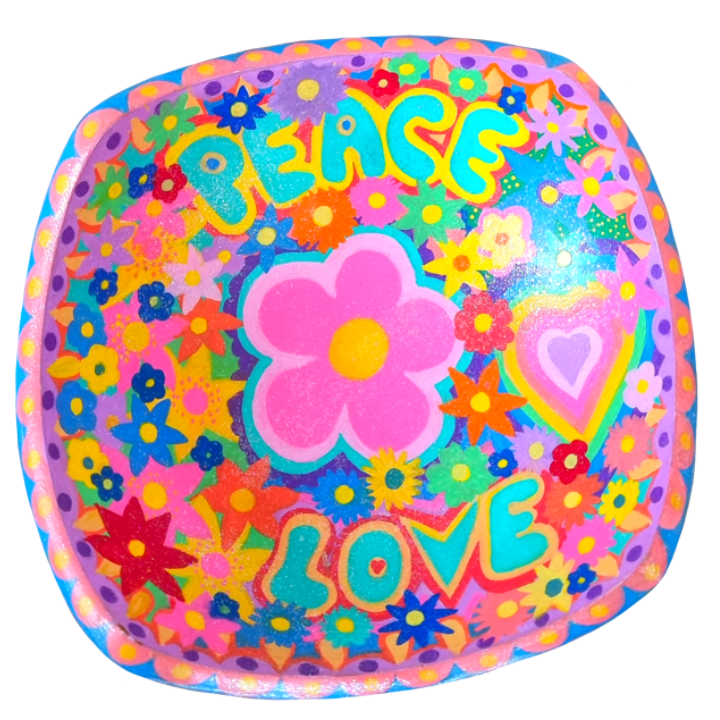 Colourful decorative bowl with the words 'PEACE' and 'LOVE' surrounded by bright flowers, hearts, and rainbow patterns.