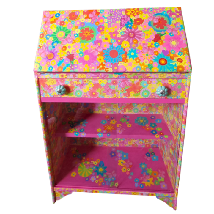 Colourful small cabinet decorated with vibrant floral pattern, three shelves, and two drawers with flower-shaped knobs.
