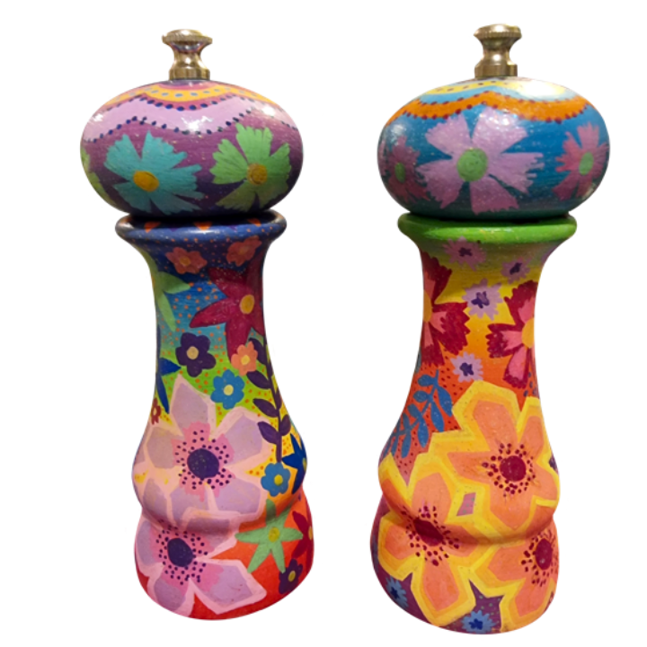 Colourful, hand-painted wooden salt and pepper shakers with floral patterns and vibrant colors.
