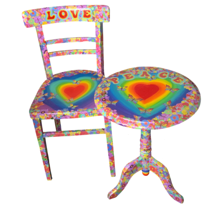 Colourful chair and table decorated with rainbow hearts, butterflies, and floral patterns, featuring the words LOVE and PEACE.