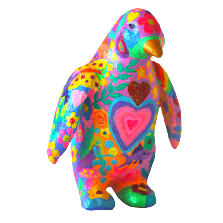 Colourful penguin ornament decorated with vibrant hearts, flowers, and abstract patterns.