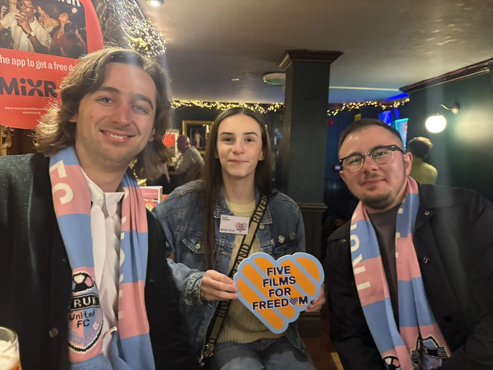 Director Cameron Richards, TRUK United player Emily and Director Charlie Tidmas at a pub after a screening of We'll Go Down in History